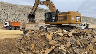 Caterpillar Excavator Loading stones onto trucks [upl. by Botti]