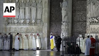 Archbishop knocks on doors of Notre Dame at reopening ceremony [upl. by Dercy]