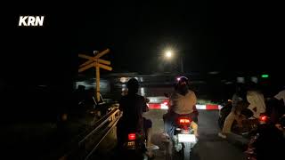 The TAKSAKA train crosses the railroad crossing in Notog village at night in Indonesia [upl. by Asilim]