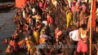 Devotees take ritual bath in Ganga river to mark the Shivratri festival Varanasi [upl. by Boleslaw]