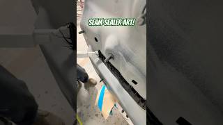 Laying seam sealer on this BMW after replacing the rear body panel seamsealer autobody collision [upl. by Naerda]