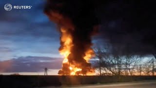 Fire after Ukraine drone attacks Russian oil depot  REUTERS [upl. by Anaiq]