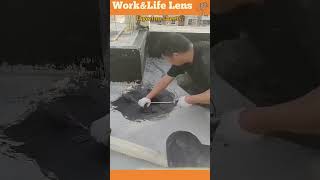 Worker applies bitumen sheets to flat roof holes fusing with heat for waterproofing [upl. by Lowenstein]