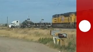 Dramatic footage Train hits trailer truck stuck on tracks Holy smokes says witness [upl. by Leunamne651]