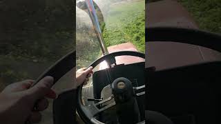 Haybine pushes tractor down hill [upl. by Drannek]