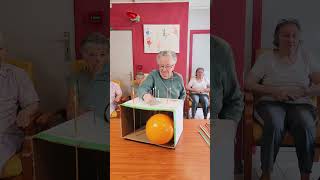 Players push long pins through a cardboard box attempting to pop the balloon [upl. by Nottap587]