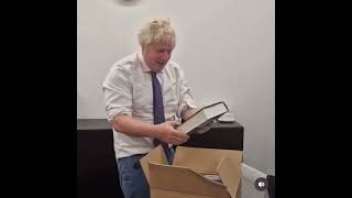 Boris Johnson opens a box full of copies of his book [upl. by An]