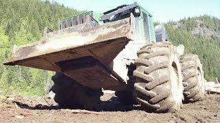 John deere skidder pulling Kenworth T800 log truck up steep hill [upl. by Sikram]