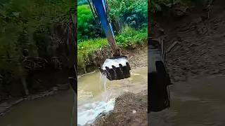 Excavator moving water from puddles work shorts [upl. by Aihsemak]