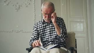 An elderly man sits in an armchair and falls asleep with a book dementia [upl. by Larrie340]