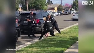 Police officers stop fellow officer punching handcuffed woman during arrest [upl. by Conyers803]