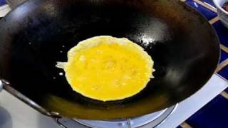 Scrambling eggs in a wok [upl. by Aibsel]